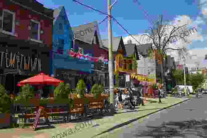 A Vibrant Street Scene In Kensington Market, With Colorful Buildings And Cafes Lining The Sidewalks. Kensington Market: The Story Of A Toronto Neighbourhood